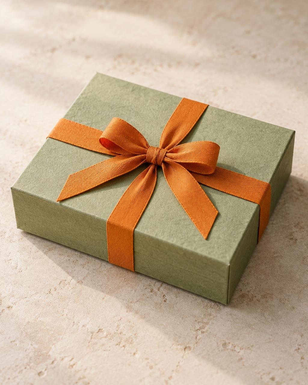 The Discovery Box: closed pistachio-green box with saffron bow