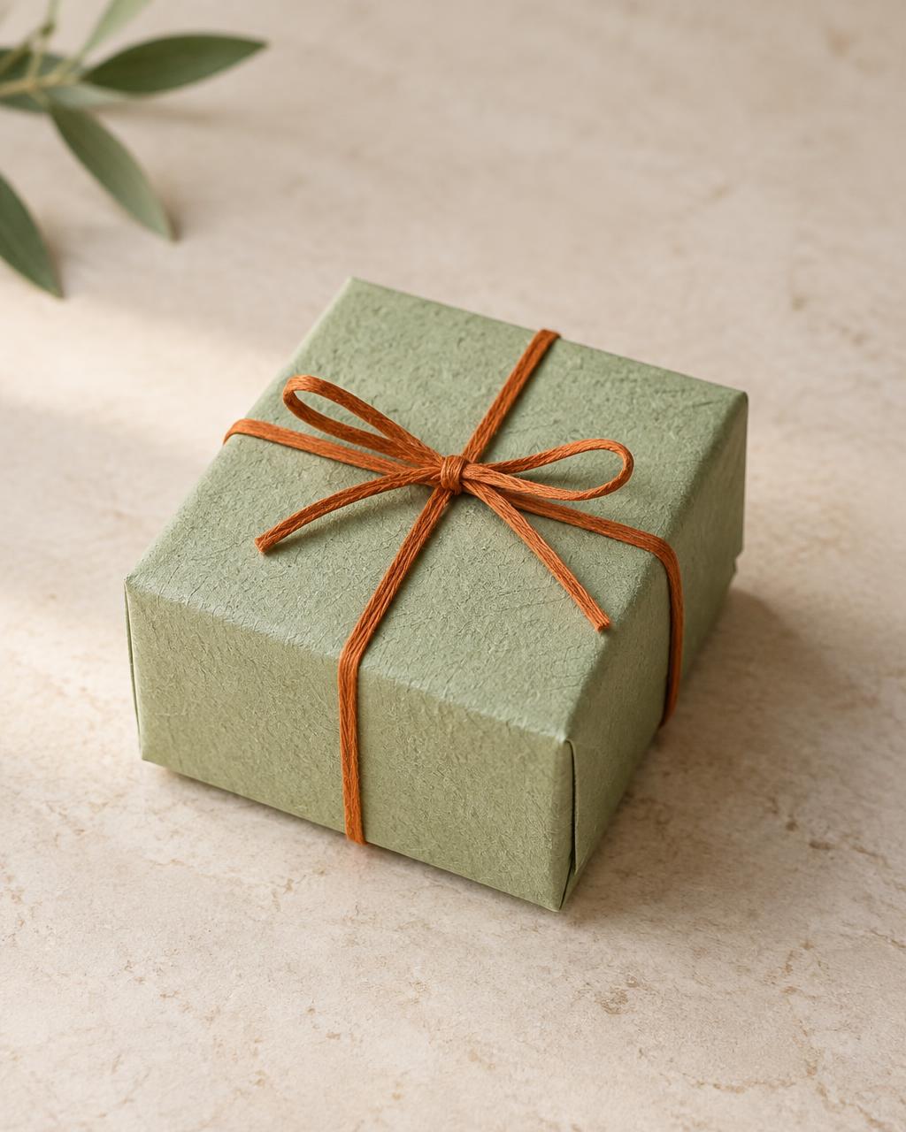 The Little Katori: closed pistachio-green gift box with saffron ribbon